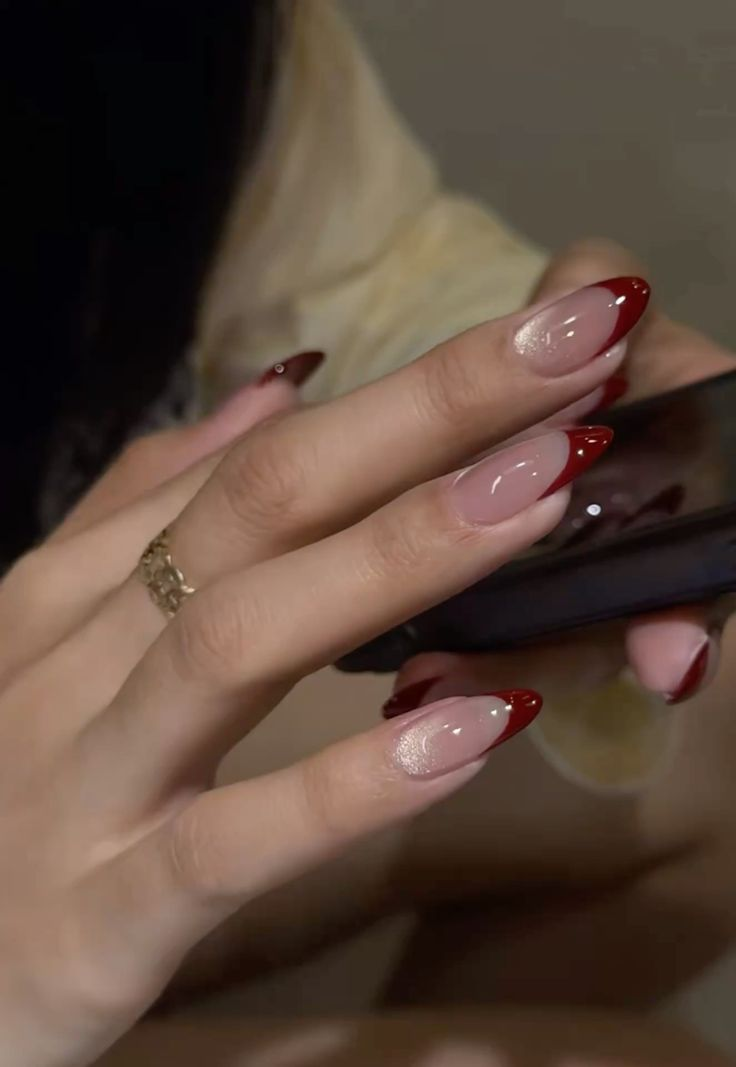 Deep red French tips with a shimmer accent nail